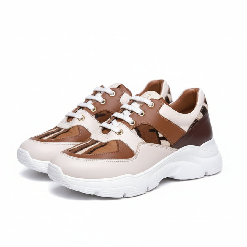 Caractéristiques: * Tige: En cuir véritable et tissu bogolan * Semelle intérieure: Confort orthopédique * Semelle extérieure: Caoutchouc robuste pour une adhérence optimale * Fermeture: Lacets en coton renforcé * Couleur: Mélange de blanc, beige et marron * Taille disponible: Du 36 au 45 Avantages: * Confort: Conception ergonomique pour un usage quotidien * Durabilité: Matériaux de haute qualité pour une longue durée de vie * Style: Design contemporain avec une touche culturelle unique * Polyvalence: Idéale